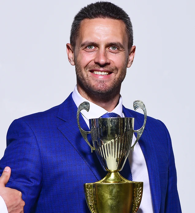 A man with a trophy in his hand.
