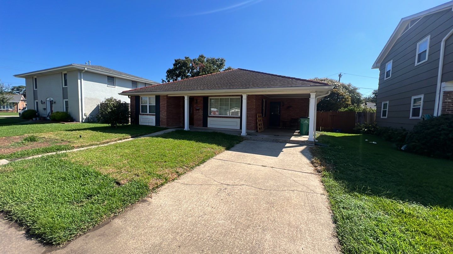 A house in a neighborhood with a driveway.
