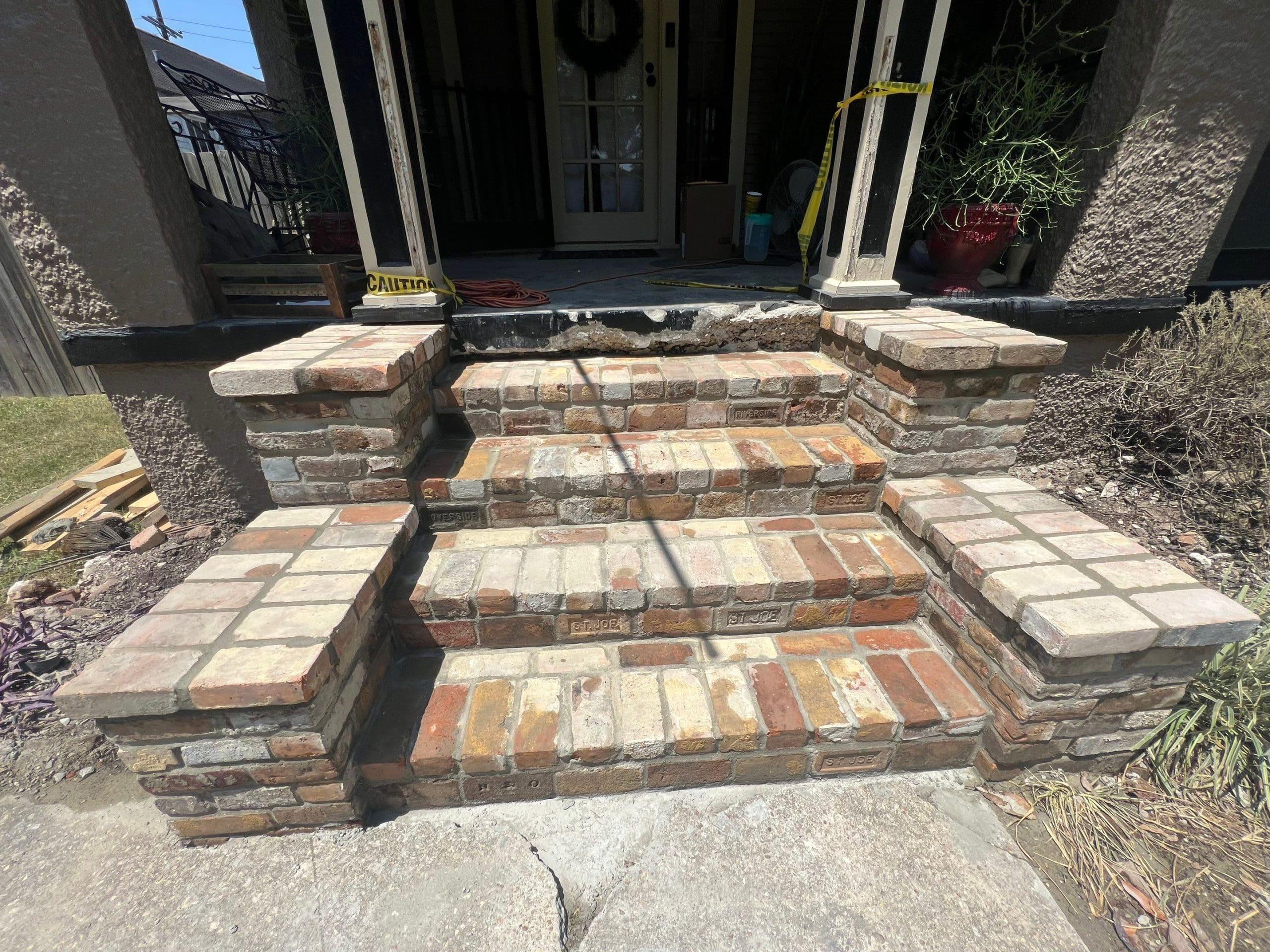 A brick house with front steps.