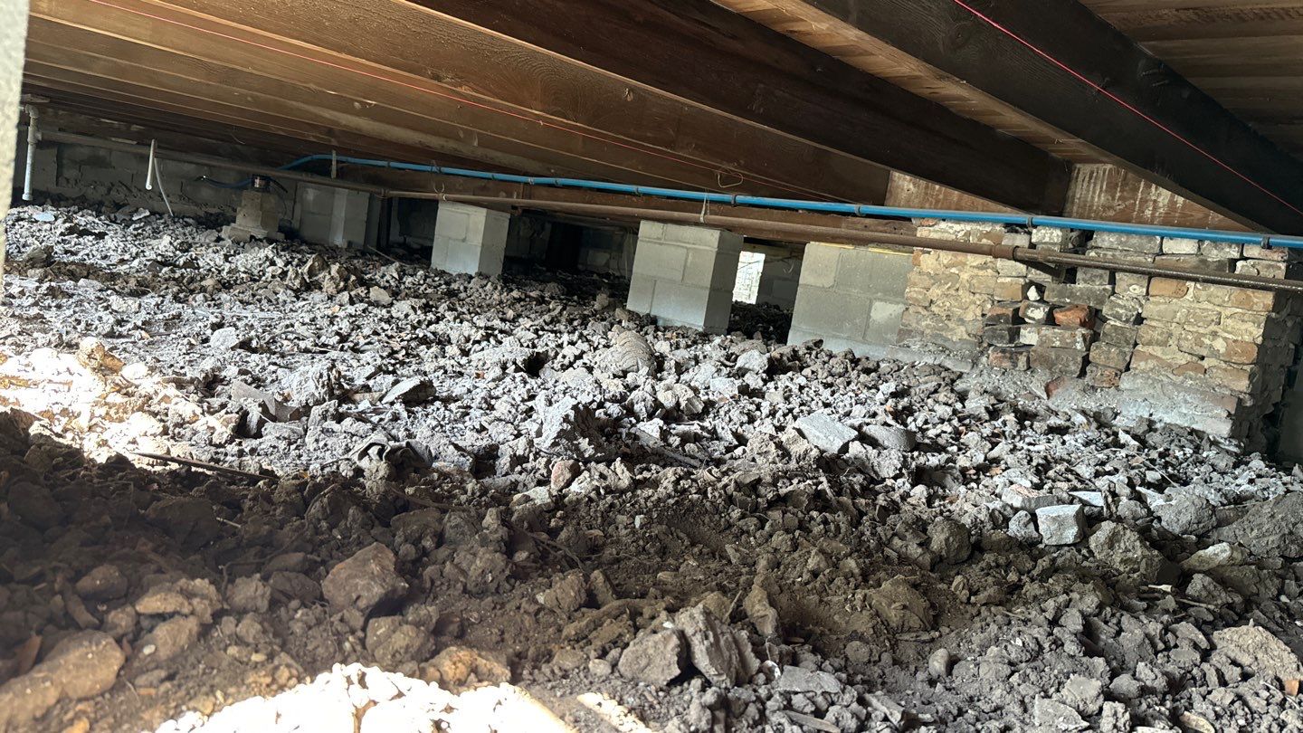 A room with a lot of dirt and rocks in it.